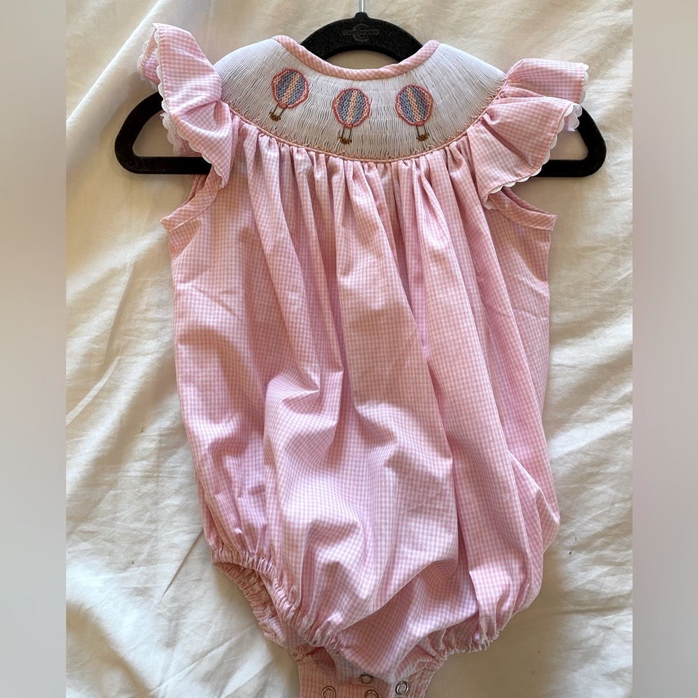 Pink gingham bubble with smocked hot air balloon collar and ruffle sleeves.